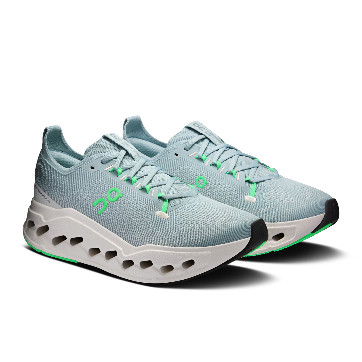 Men's running shoes, side view: textured light blue upper, green laces, white sole