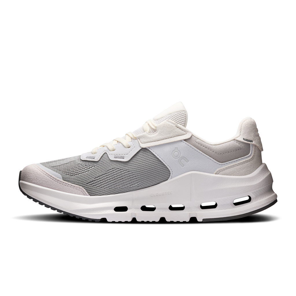 Women's running shoe with gray knit upper, white midsole cutouts, and strap closure