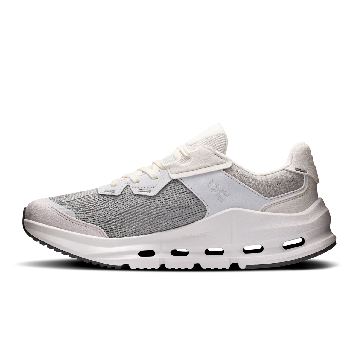 Women's running shoe with gray knit upper, white midsole cutouts, and strap closure