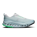 On women's trail running shoes, light blue mesh upper, white laces, green accents