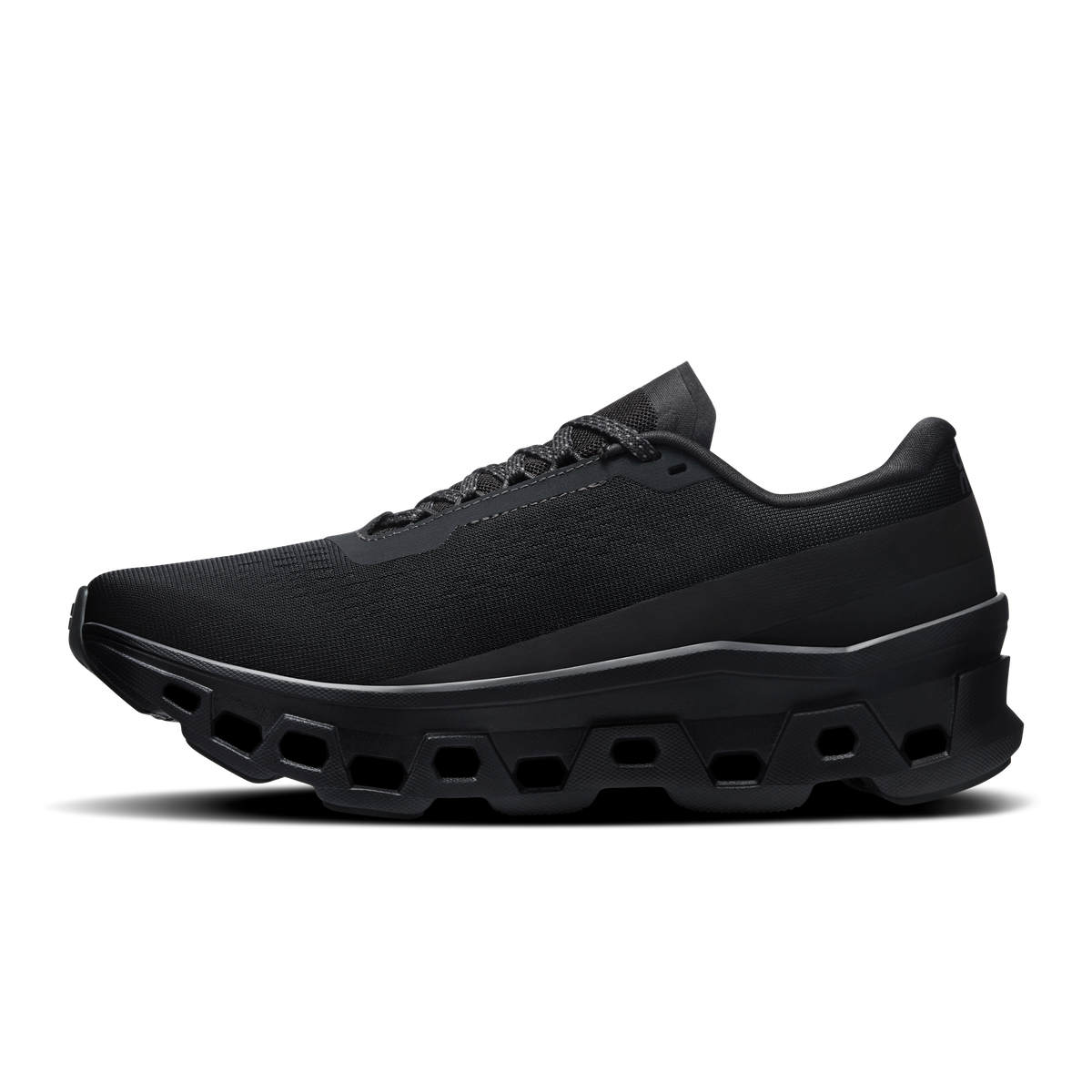 On Cloudmonster 1 women's black running shoes, front side profile with rocker sole.