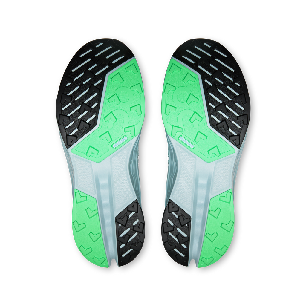 On women's trail shoe outsoles, green grip lugs with black traction sections