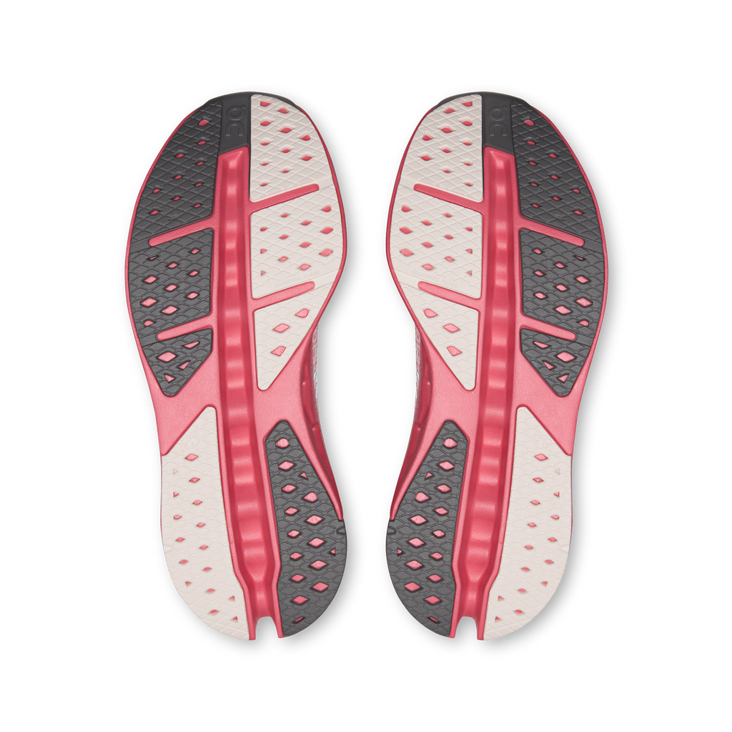 Women's running shoes, underside view with textured pink-and-white traction pods