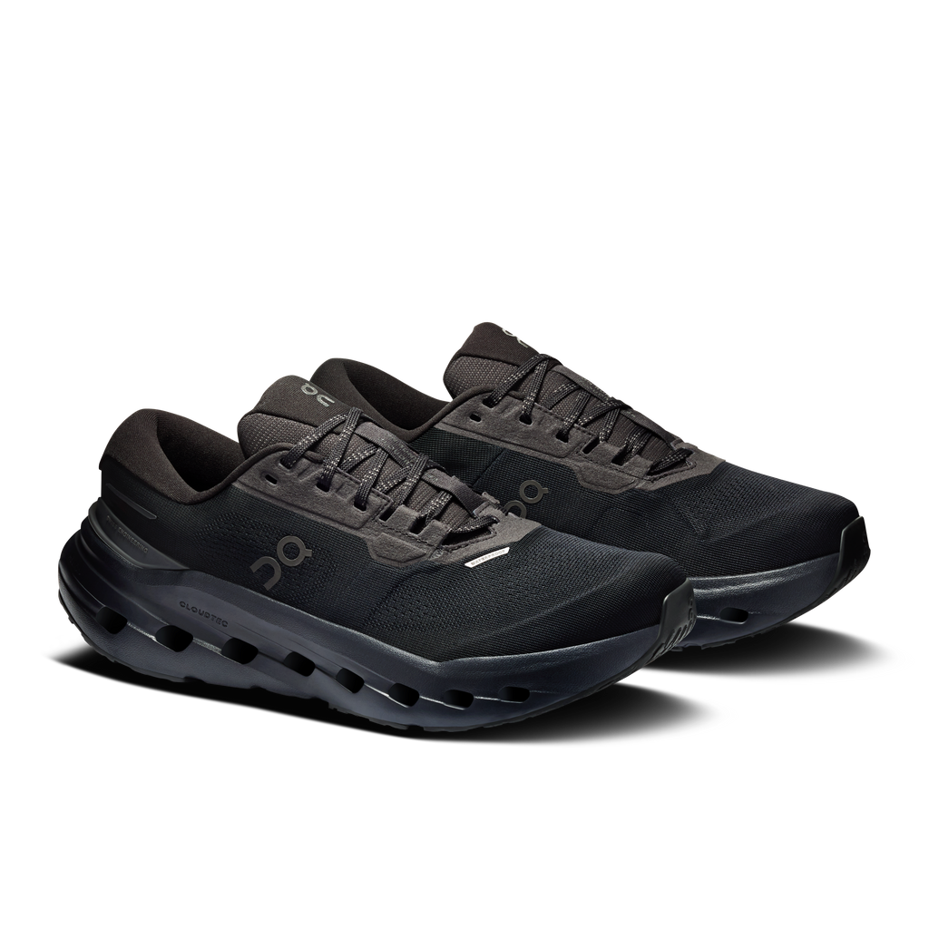 Women's waterproof running shoes pair, black lace-up with CloudTec pod outsole