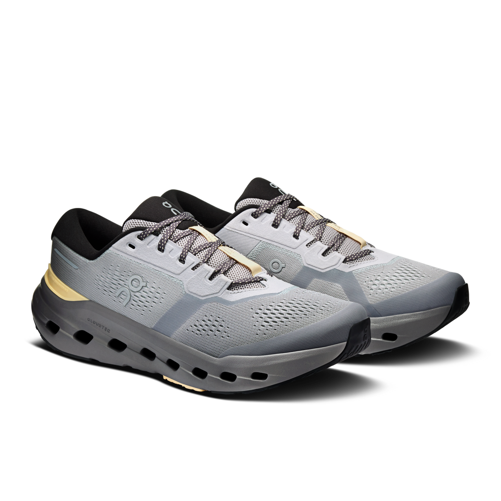 Men's running shoes, light gray knit upper with gold side stripe and black outsole pods