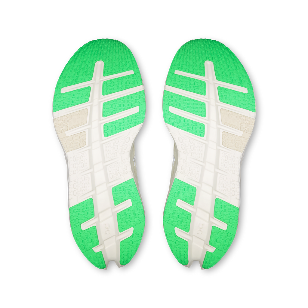 Shoe outsoles pair with textured tread in bright green and white, On logo details