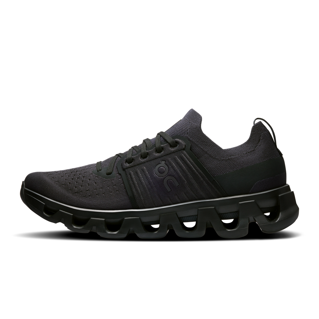 Men's black running shoes with lace-up knit upper and green accent overlays