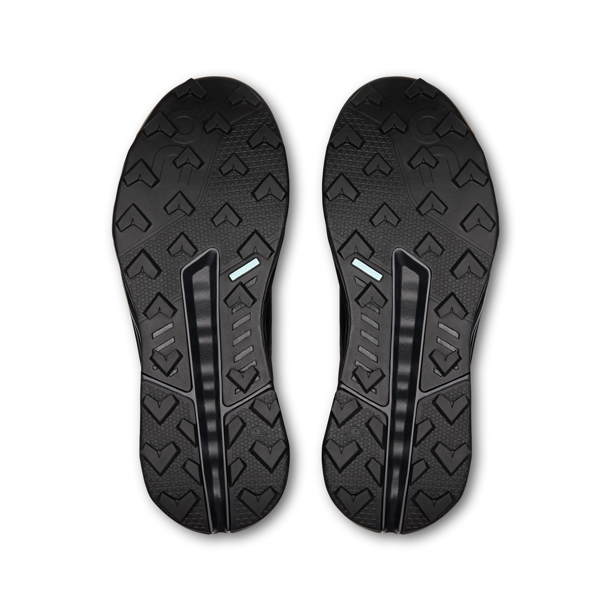 Dark shoe outsoles with raised tread pattern and deep grooves, pair view