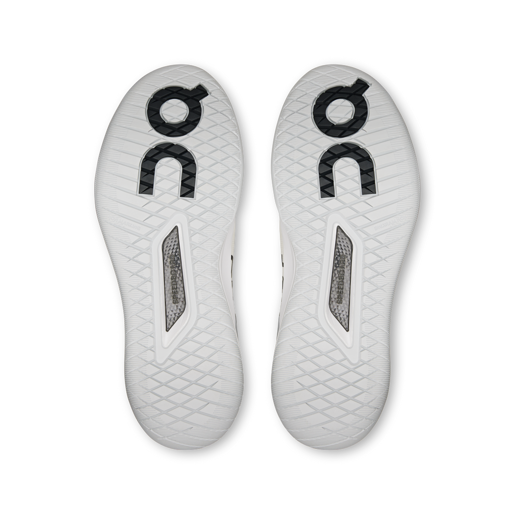 Pair of white sneaker outsoles with tread pattern and circular On branding