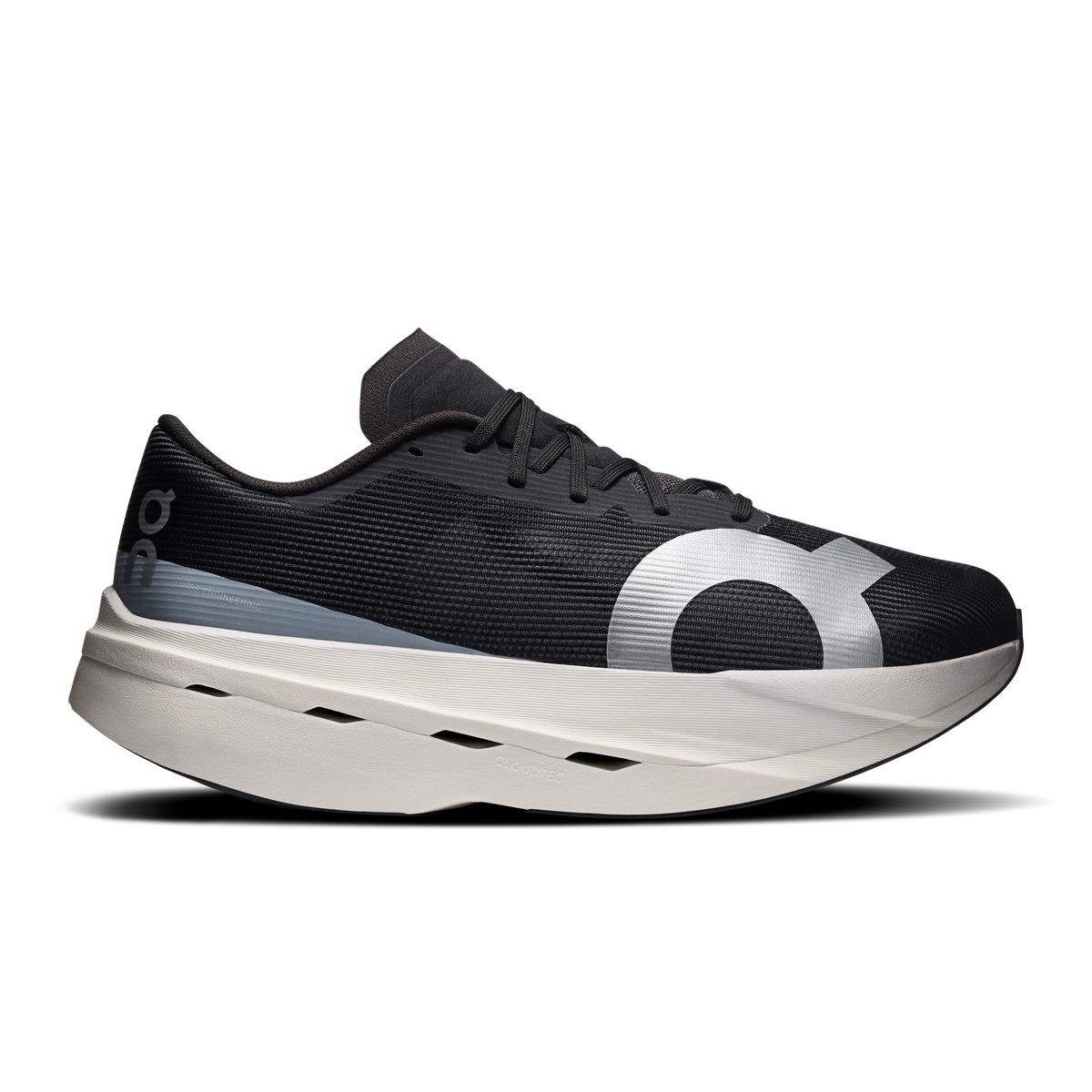 On men's running shoes, black mesh upper with lace-up front and white Cloud-style sole