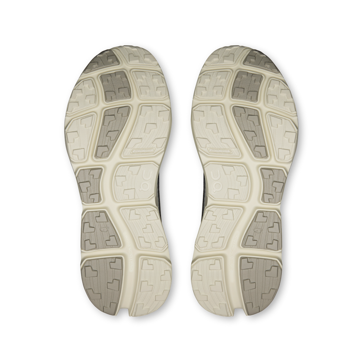 Pair of men's trail shoe outsoles with rugged geometric tread, light tan
