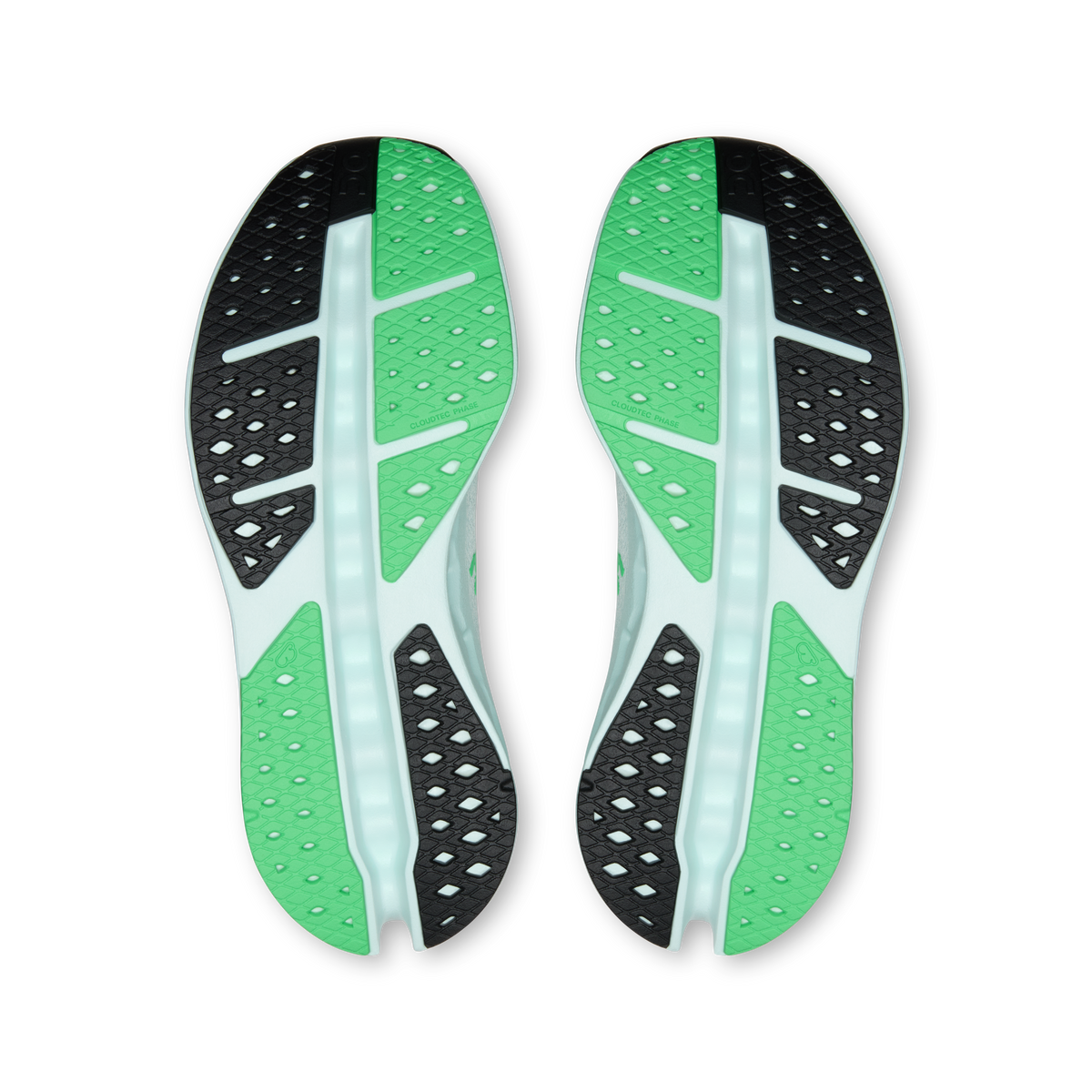 Shoe outsole view with green tread pods and black traction sections