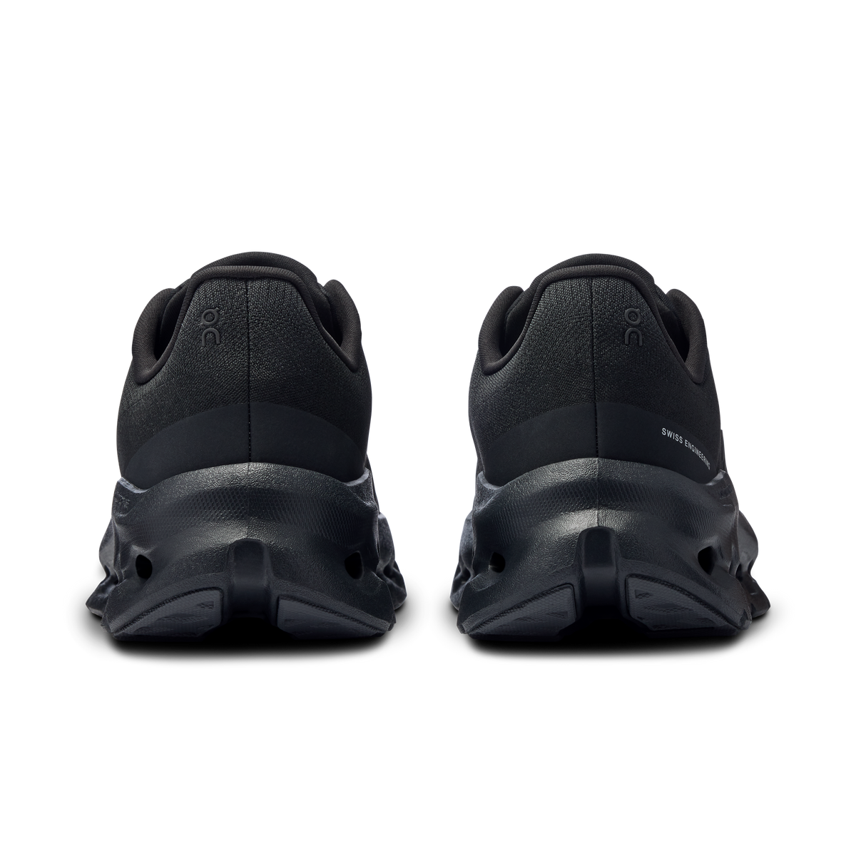 Women's black running shoes, heel view with cushioned back and outsole pods