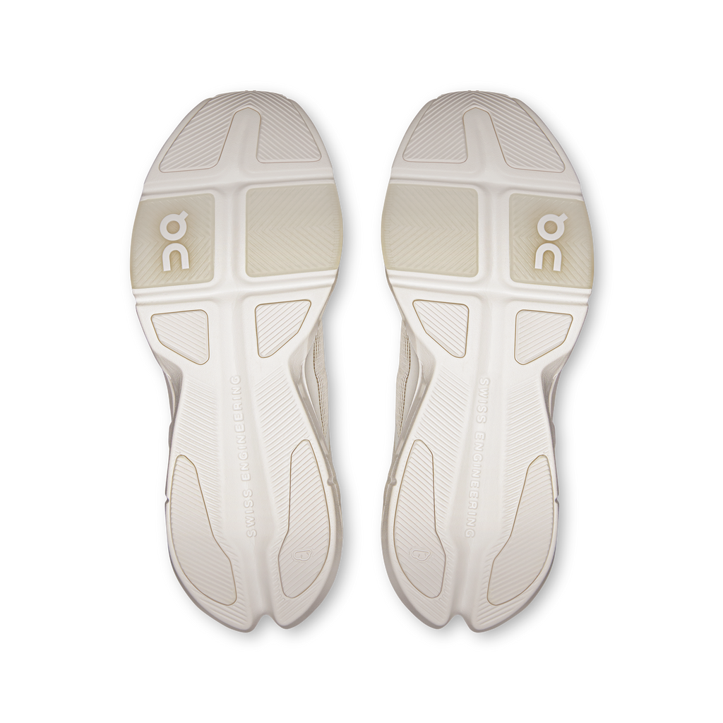 Pair of white outsoles with On logo and traction tread for running shoes