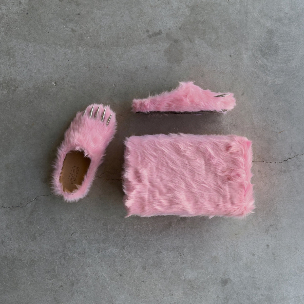 Pink bear claw mules laid flat: plush slide with claw openings