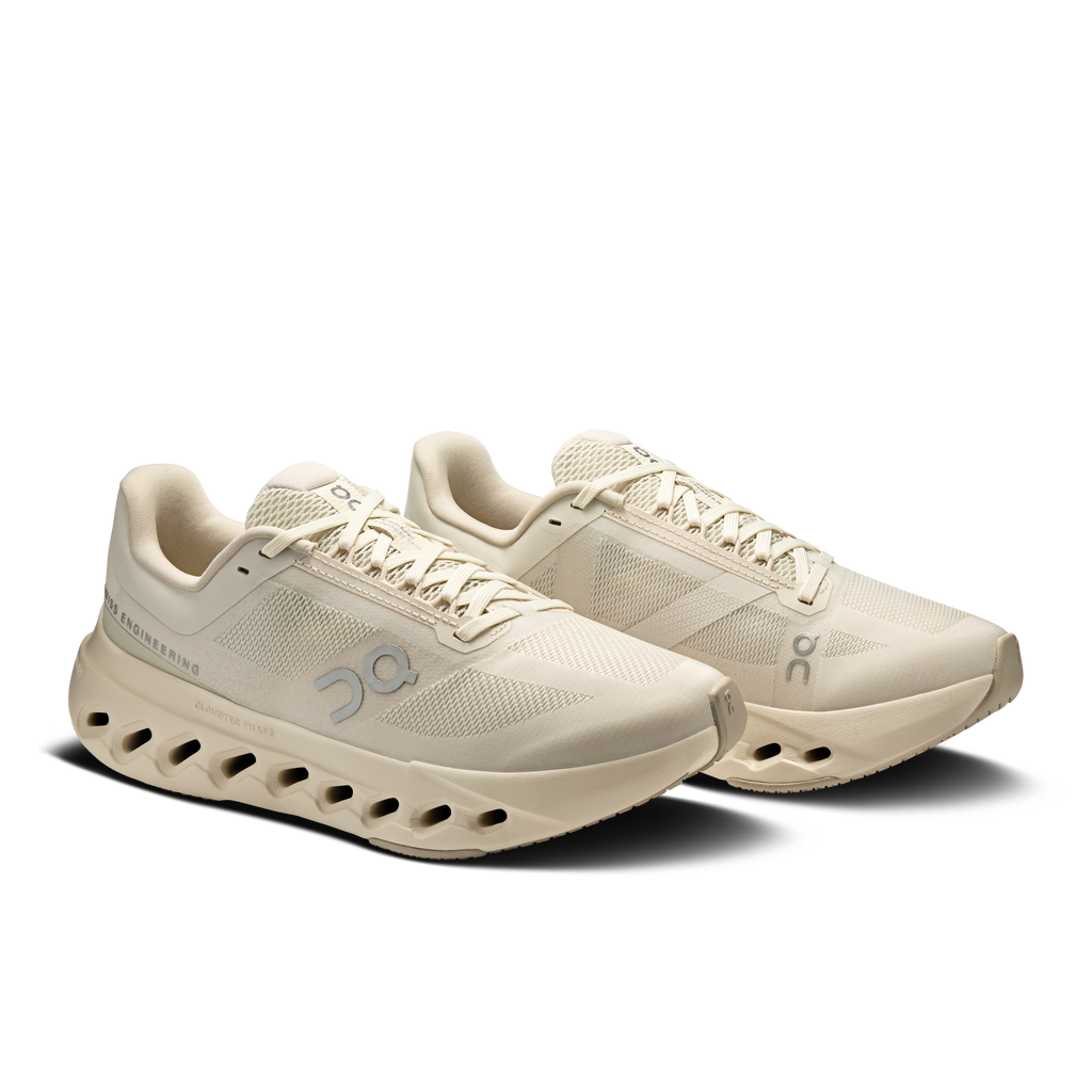 Pair of women's running shoes in light beige with lace-up mesh and cushioned outsole