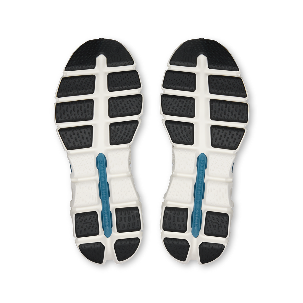 Running shoe outsoles with black traction pods and blue vertical support bars
