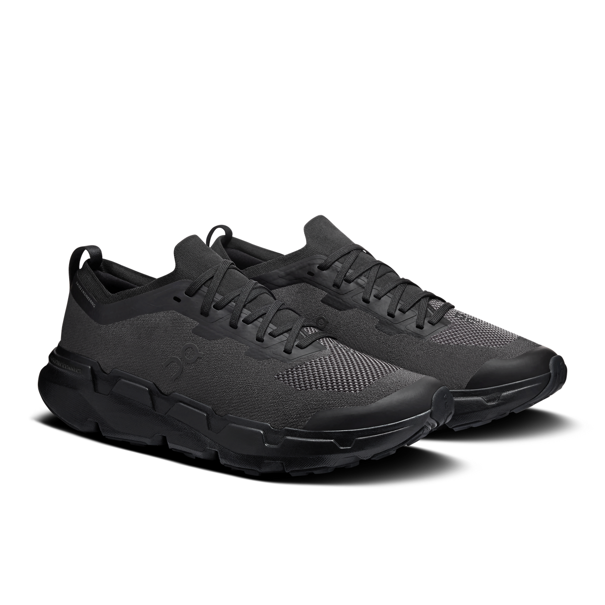 On men's black lace-up running shoes with textured upper and rugged outsole