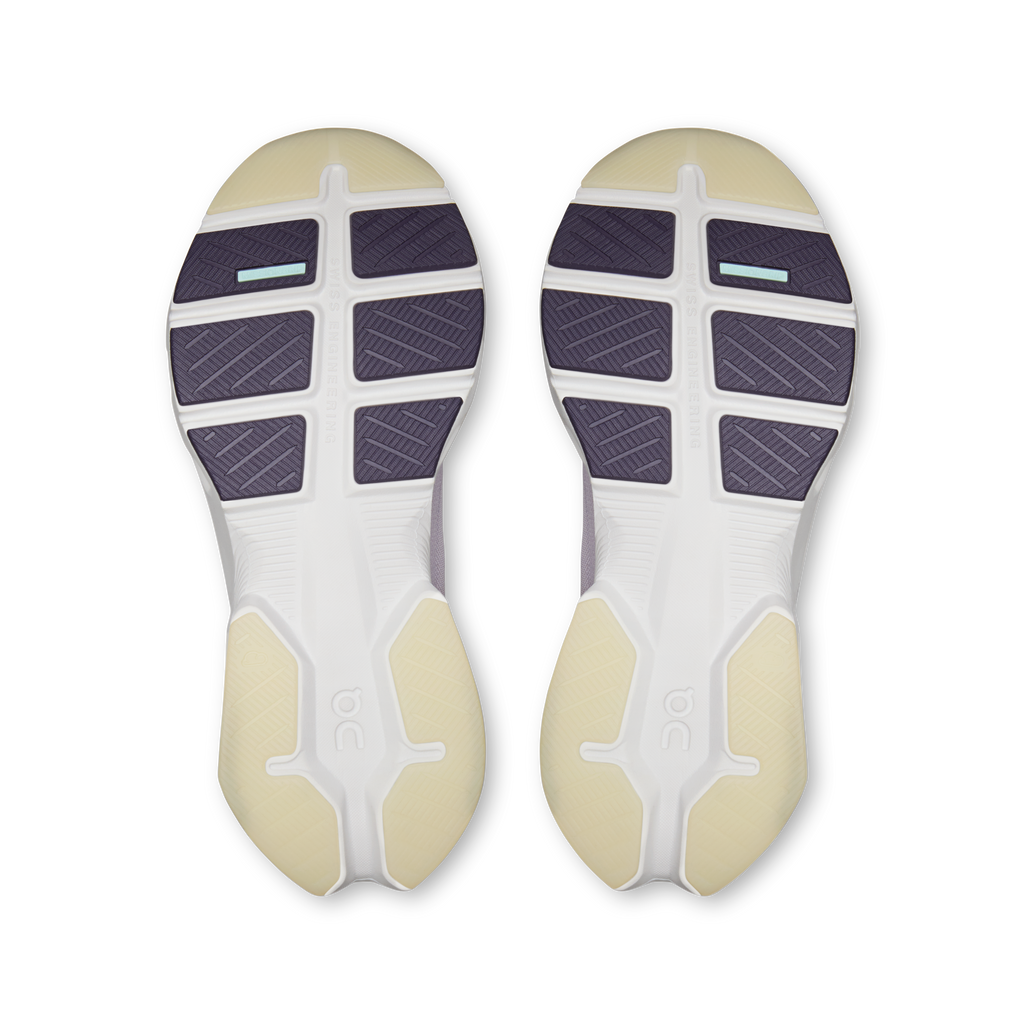 Pair of shoe outsoles with purple traction tread and white foam midsole