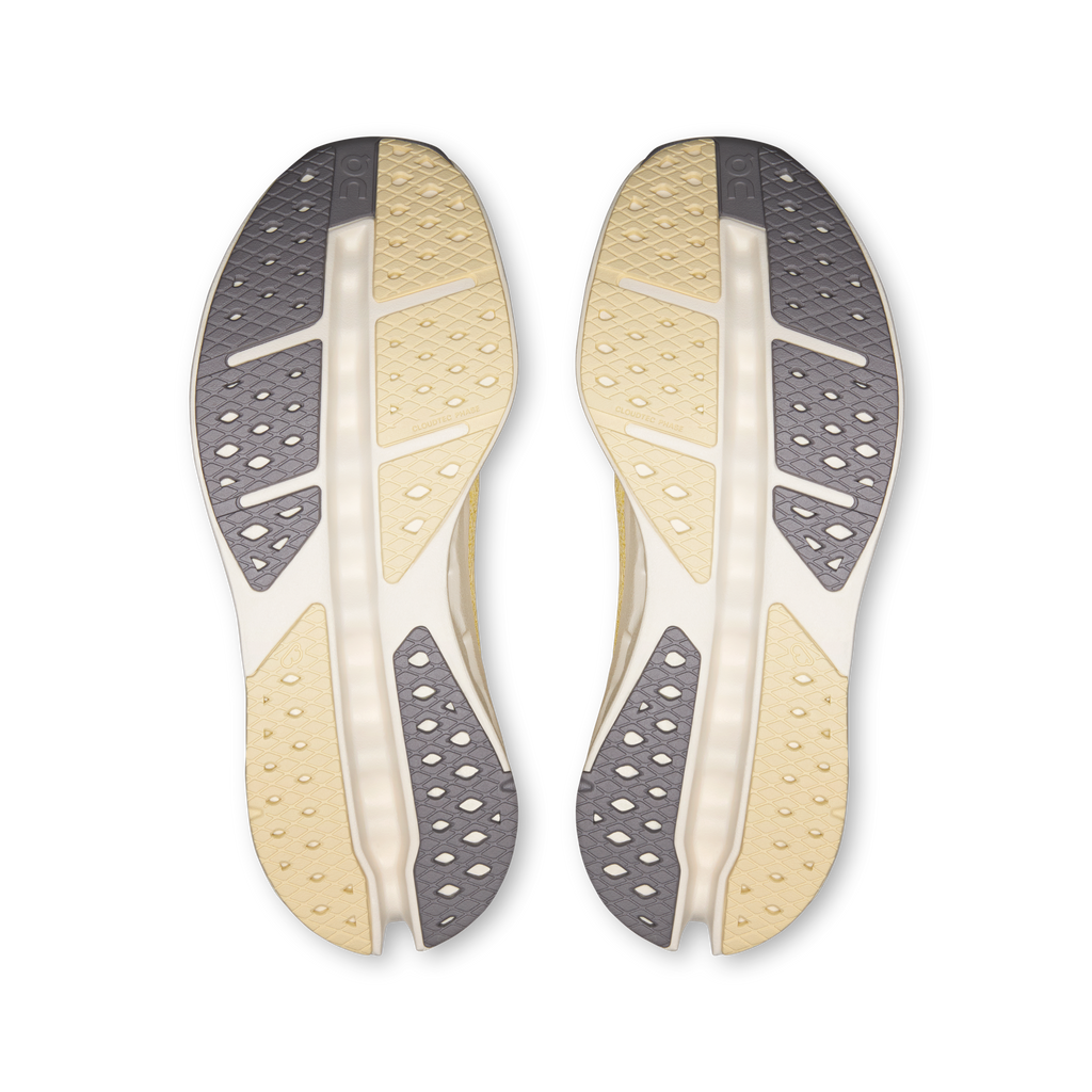 Pair of shoe outsoles, dark gray tread with light yellow and white channels