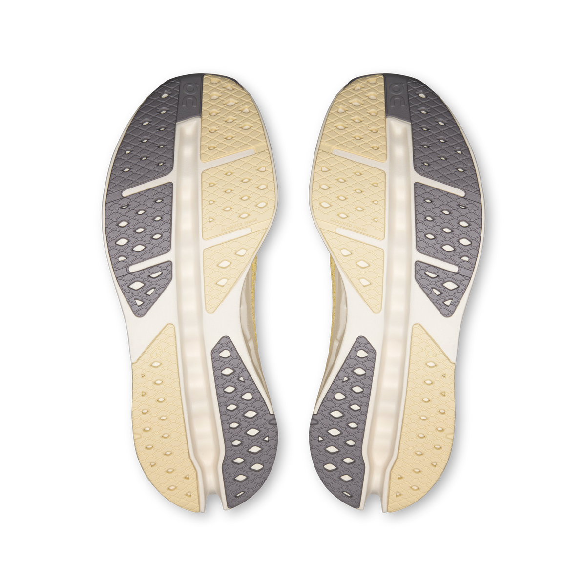 Pair of shoe outsoles, dark gray tread with light yellow and white channels