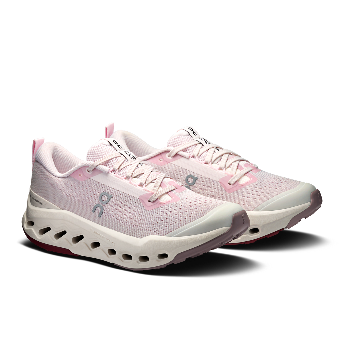 Light pink lace-up trail running shoes with mesh upper and cloud-style cushioned sole
