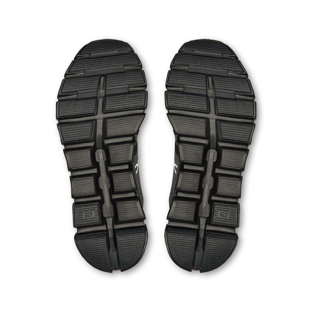 Pair of black shoe outsoles with tread pattern and rocker-style center
