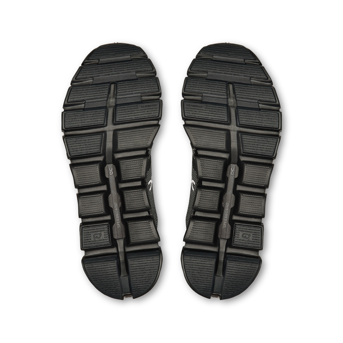 Pair of black shoe outsoles with tread pattern and rocker-style center