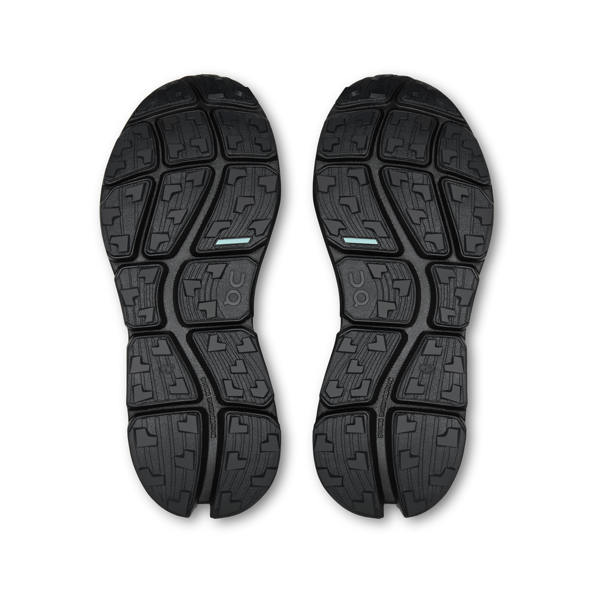 Pair of black shoe outsoles with textured rubber tread pattern