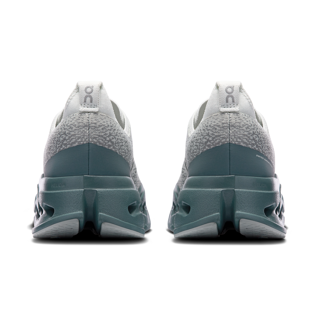 Rear view of men's light gray running shoes with teal heel and pull tab