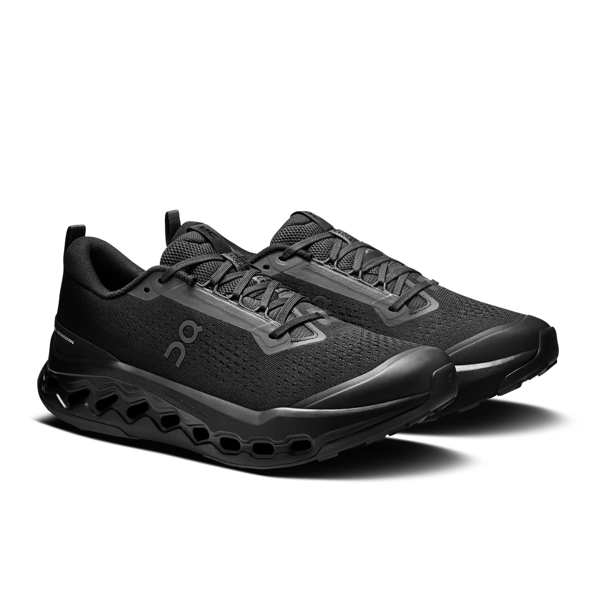 Men's black trail running shoes, side view with lace-up straps and grippy rubber sole