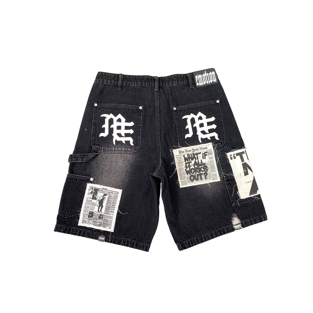 Men's black denim shorts with utility patch pockets and distressed graphic prints