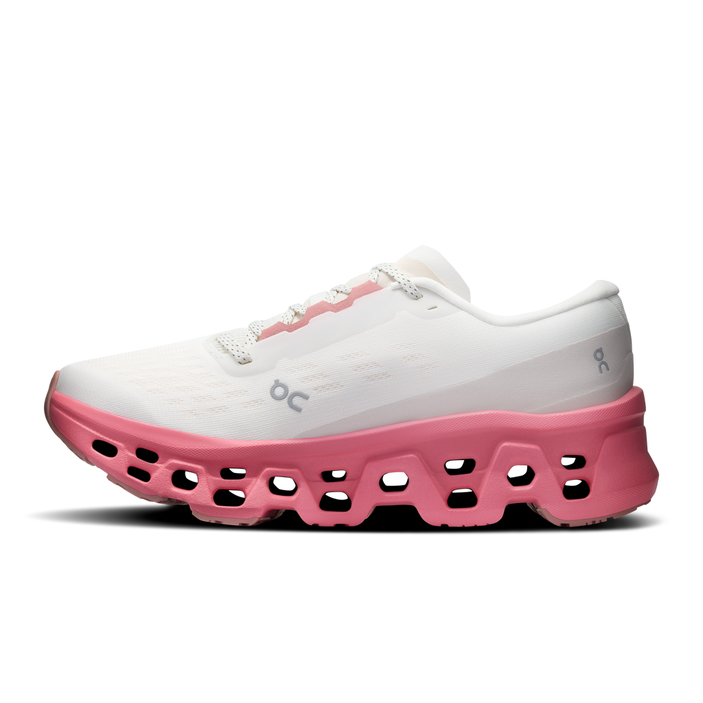 Ivory women's running shoes with pink rocker sole and logo on side