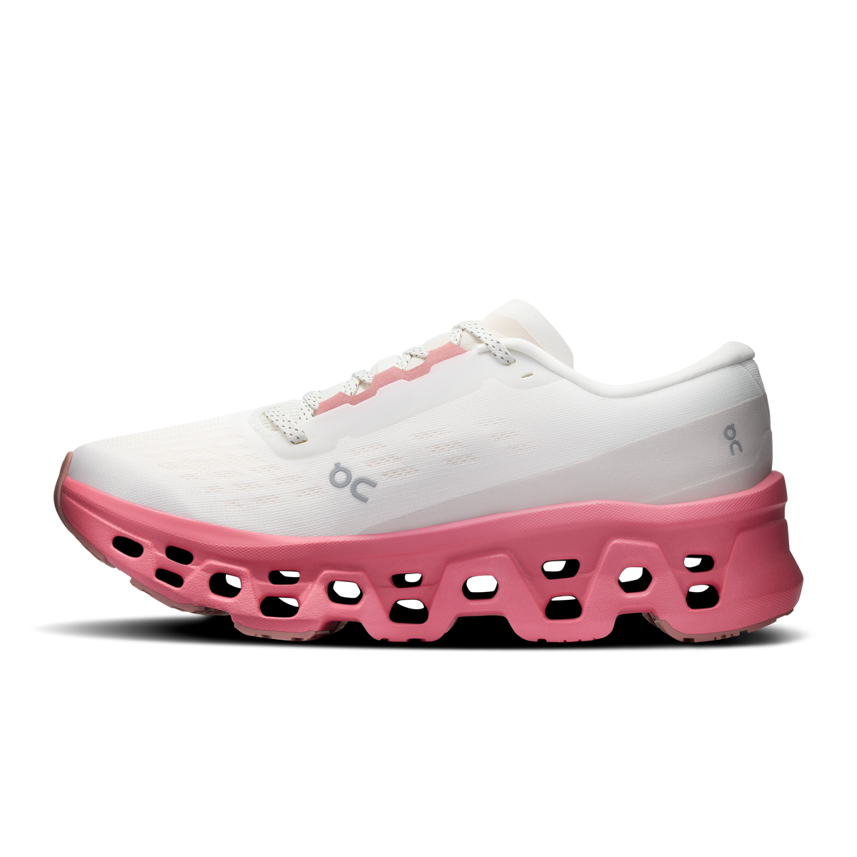 Ivory women's running shoes with pink rocker sole and logo on side