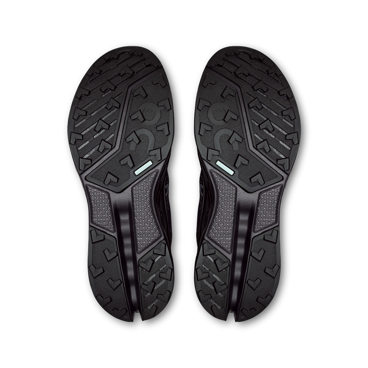 Pair of black waterproof trail shoe outsoles with rugged tread and grippy lugs