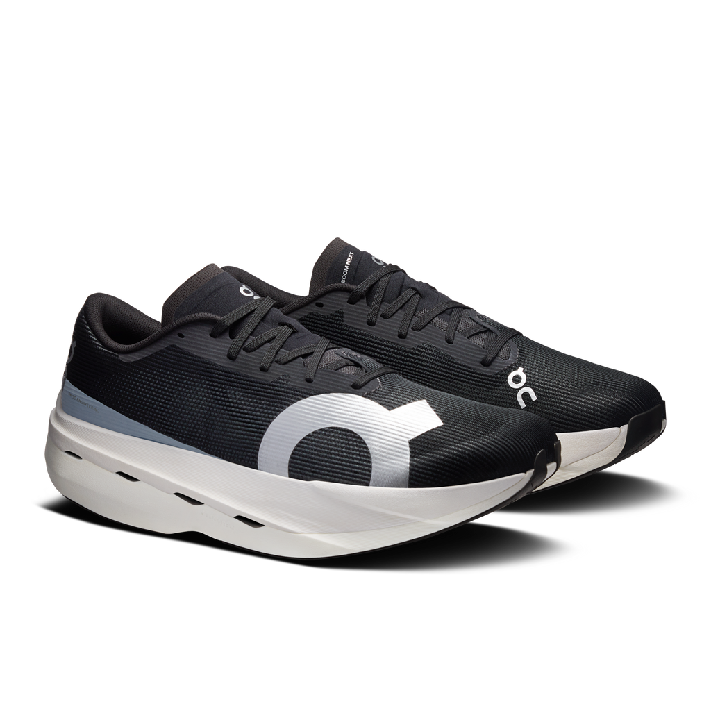 On men's running shoes, black knit upper, bold white logo, lace-up with white outsole