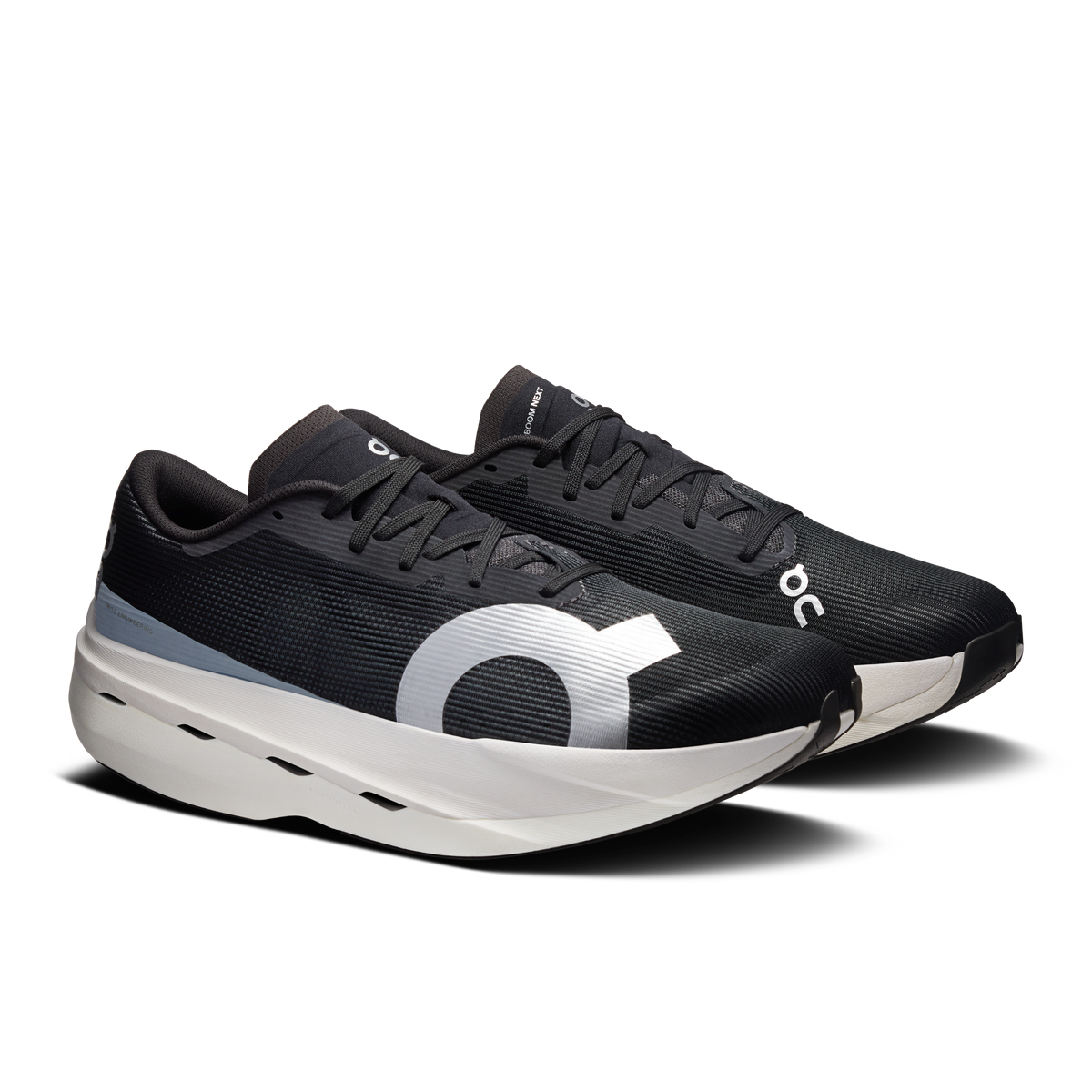On men's running shoes, black knit upper, bold white logo, lace-up with white outsole