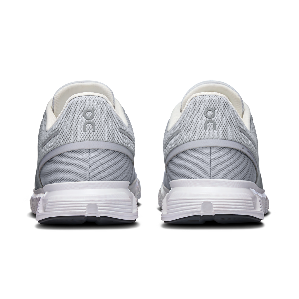 Rear view of glacier gray running shoes with padded heel and white rubber midsole