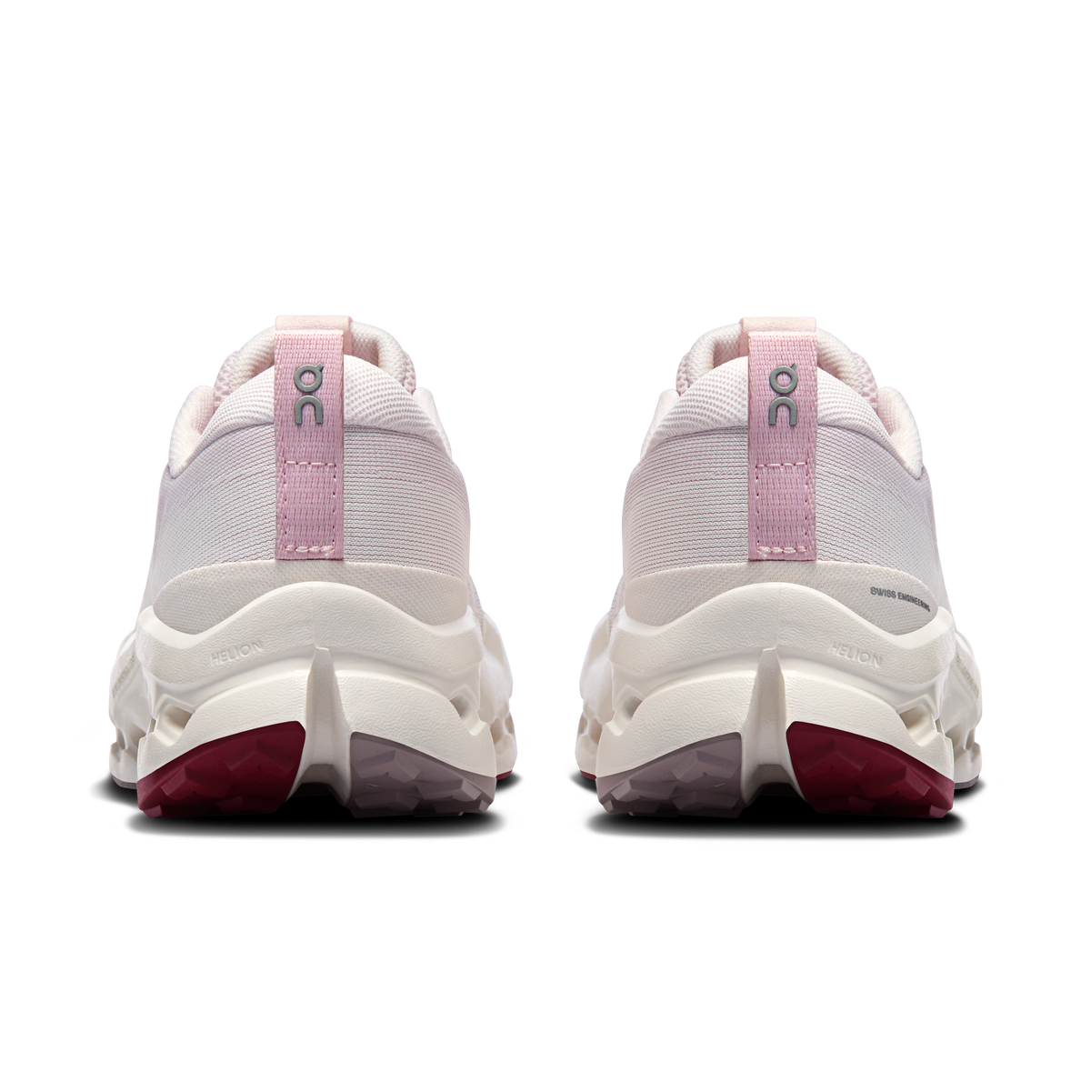 Back view of light pink trail running shoes with heel pull tab and cushioned sole