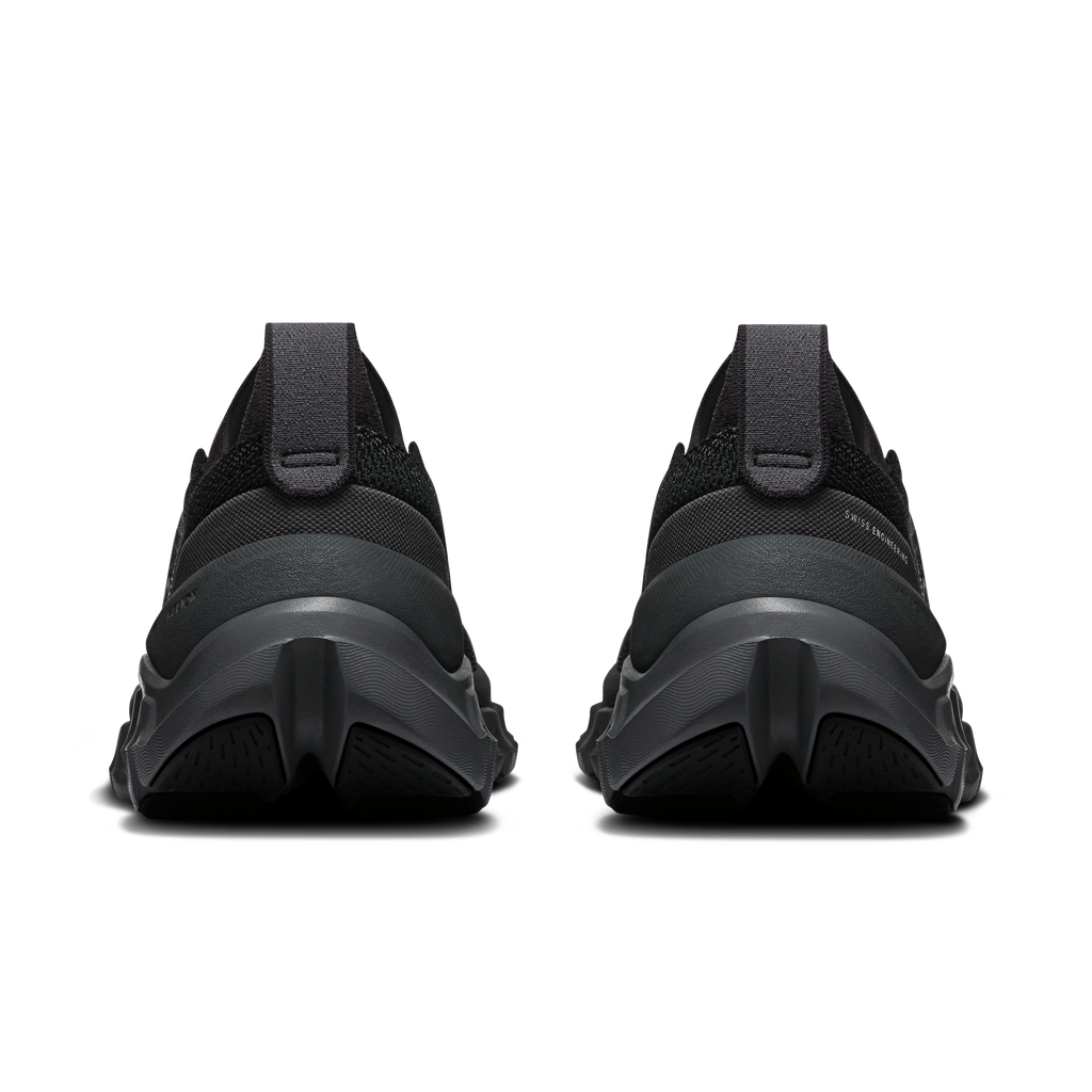 Black running shoes rear view with padded heel, thick midsole, and textured outsole