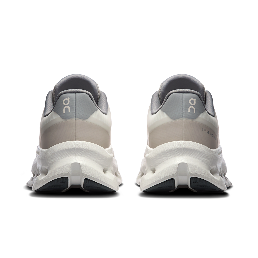 Women's heel view running shoes with padded collar, alloy accents, and cushioned sole