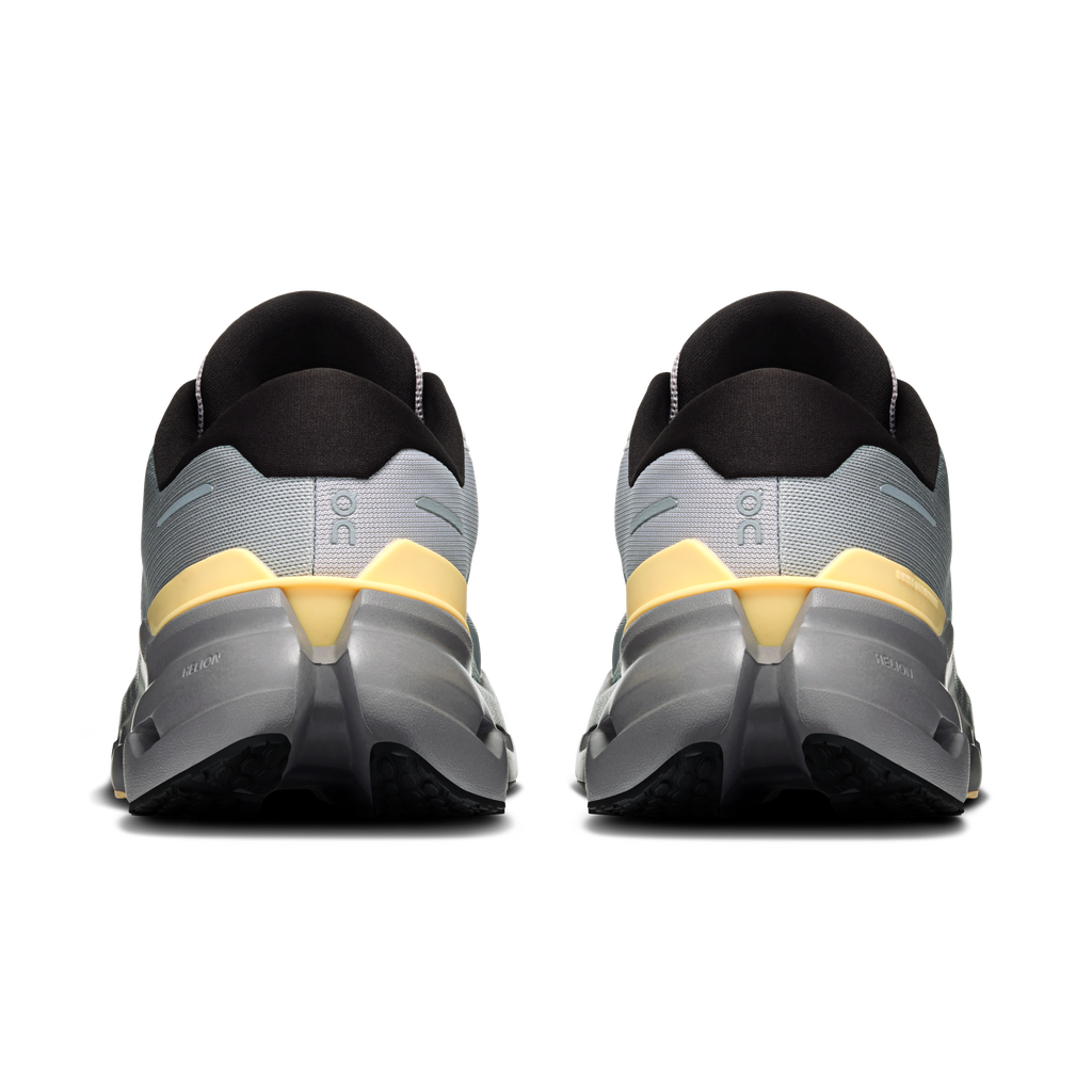 Men's running shoes heel view: dark collars, light gray uppers with gold/yellow accents