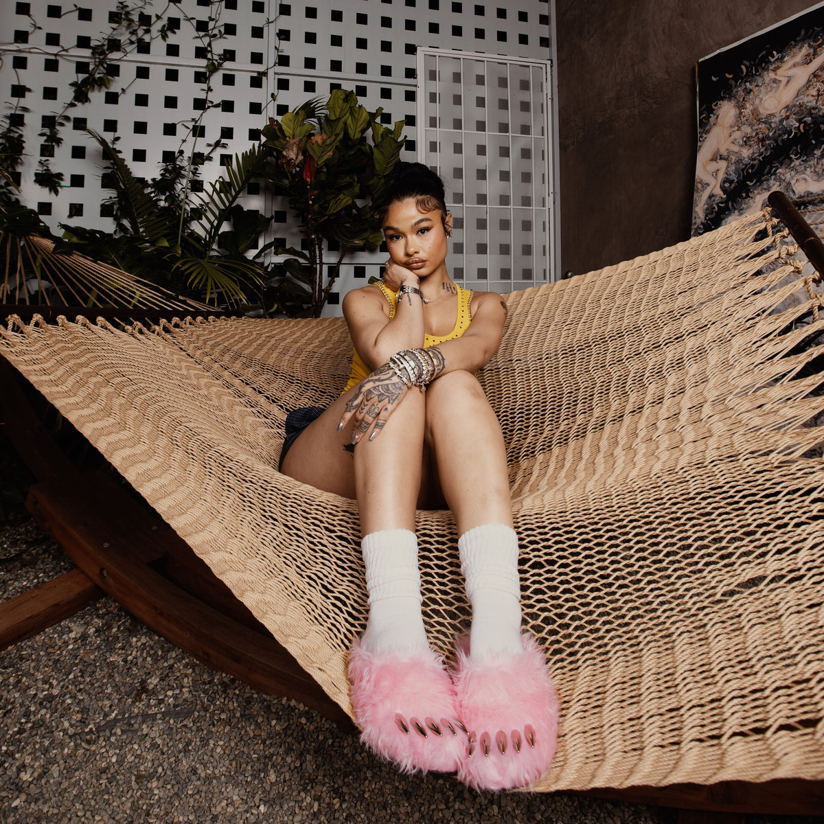 Pink bear claw mules with fluffy cuff, worn with white socks