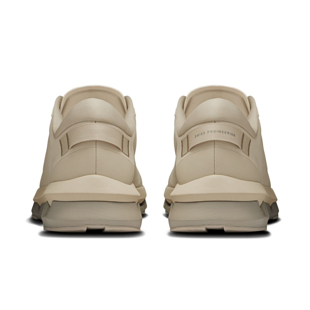 On Cloudzone running shoes in light cream, rear view with heel pull tabs