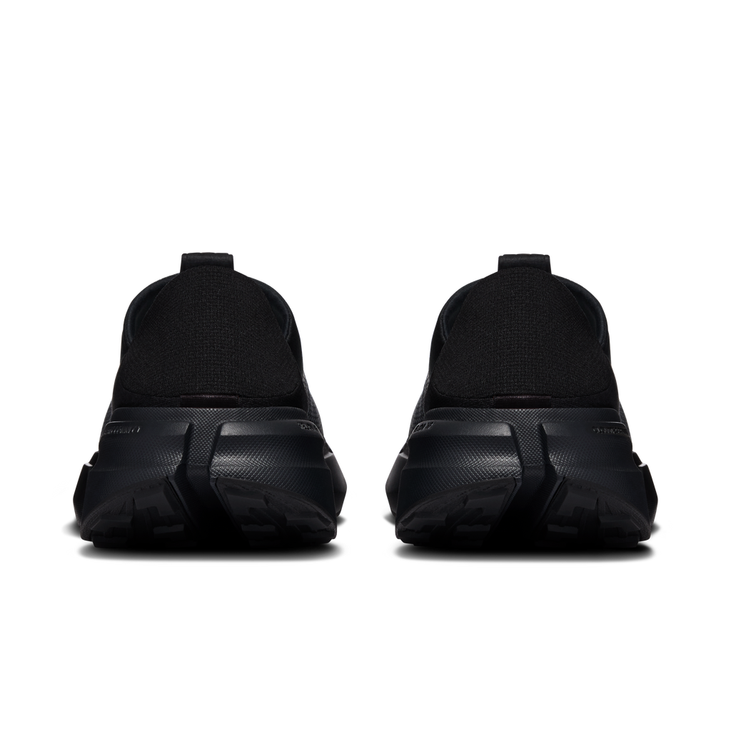 Women's black slip-on moc shoes, heel view with molded heel counter and outsole