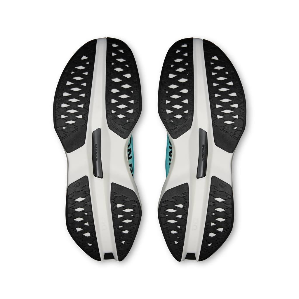 Pair of shoe outsoles with white midsole and black rubber traction pods