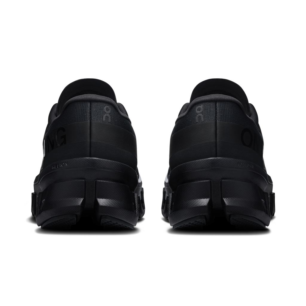 On Cloudmonster 1 women's black running shoes, heel view with padded back and midsole.
