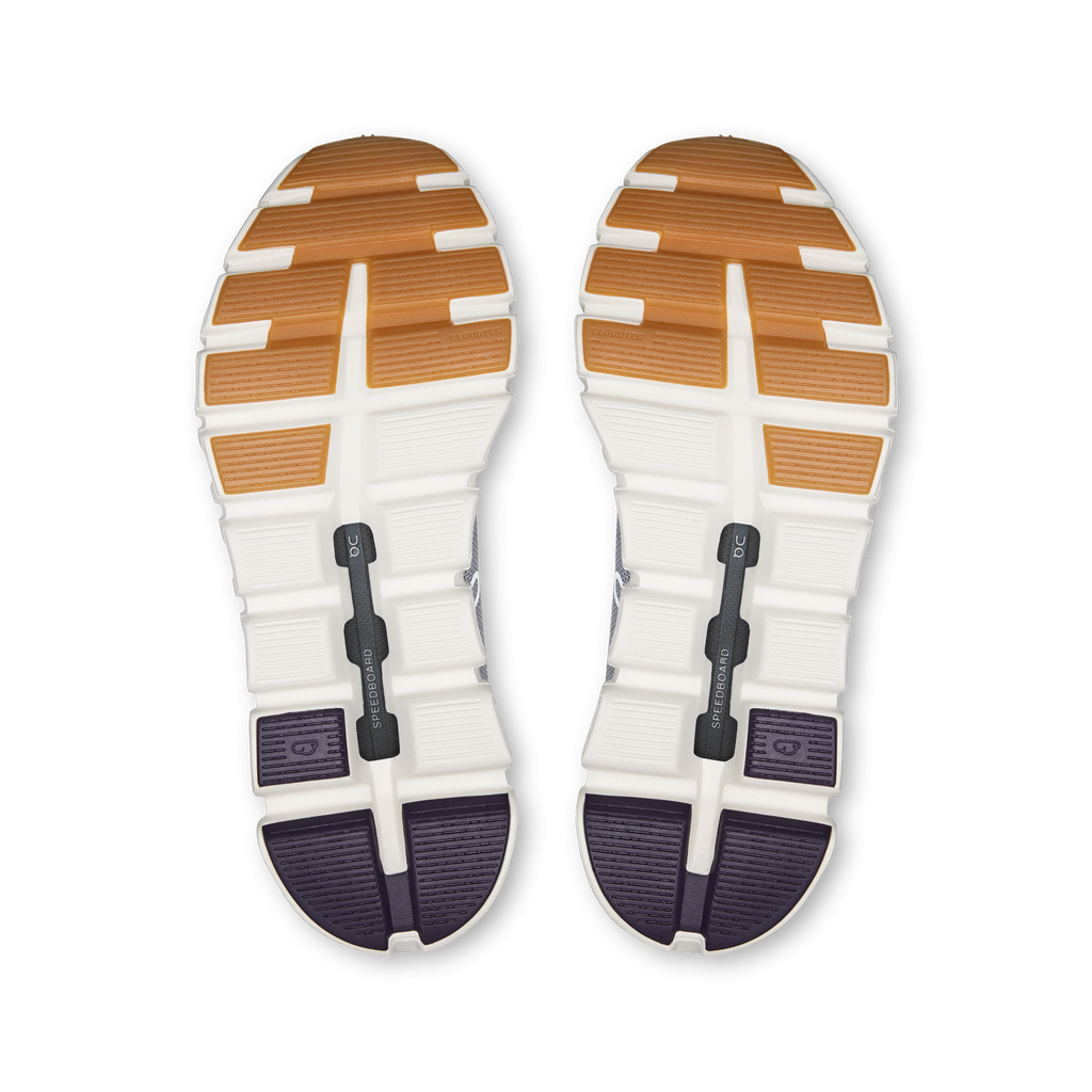 Shoe outsoles with orange traction pads and dark rubber sections