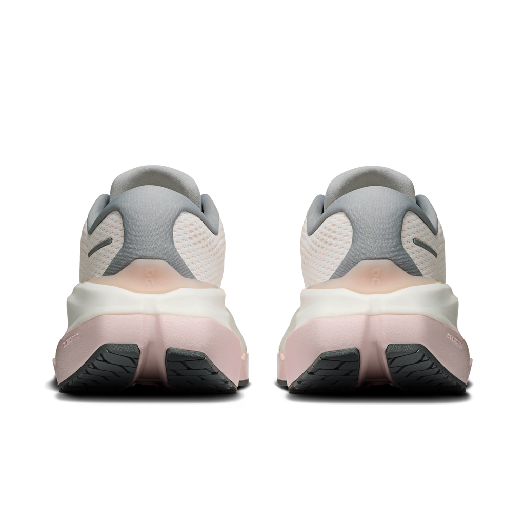 Heel and back view of white running shoes with gray collar and pink accents