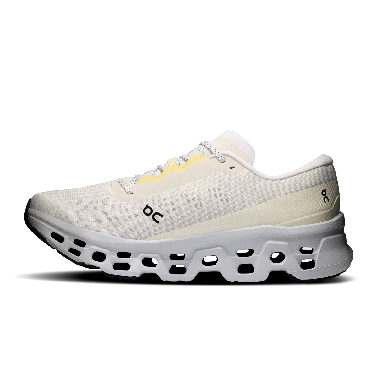 On running shoes, light beige knit upper with black heel logo and white pod midsole